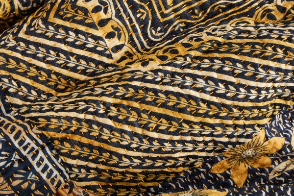Kantha hand stitches on a patterned cloth