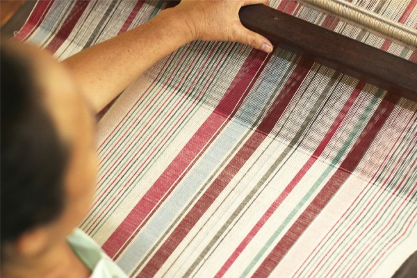 Weaver working on the stripes